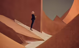 a woman standing in the desert looks out over some sand dunes