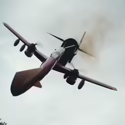 the small airplane is flying high in the sky
