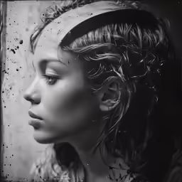 a woman with curly hair and a head band