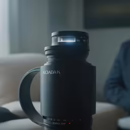 the coffee mug has a handle that holds a camera