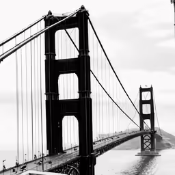 a truck is driving across the bridge in a black and white photo