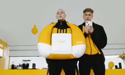 two men in black wetsuits standing beside each other