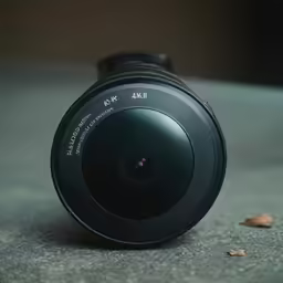 a close up of a camera lens on the ground