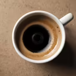 the cup is full of something brown in color
