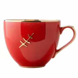 the red mug is decorated with gold details