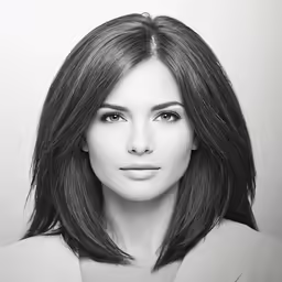 a woman in black and white is looking directly into the camera