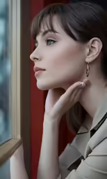 a woman wearing a trench coat looking out a window