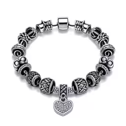 a bracelet that has a silver heart on it,silvertone heart and scroll pattern charm bracelet