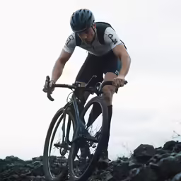 a man rides a mountain bike on a rocky trail