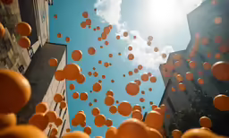 several large balloons float in the air near buildings