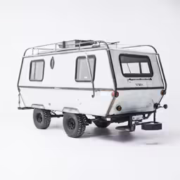 a white travel trailer parked on a snow covered ground