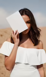the beautiful woman is holding up an empty sheet