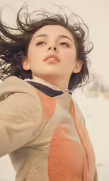 a young woman stands in a snowy landscape