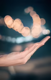 a hand with a diamond ring held out