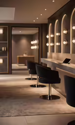 two black stools on top of a counter next to a row of chairs