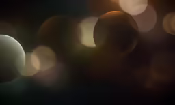 two yellow and brown circles are seen in this dark background