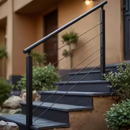 some plants and a set of stairs outside of a building