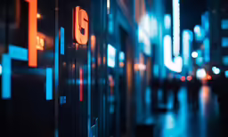 an electronic screen displays the time on an illuminated city street