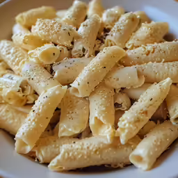 the pasta in the bowl has black pepper on it