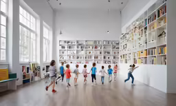 children walking in the library towards the bookshelves
