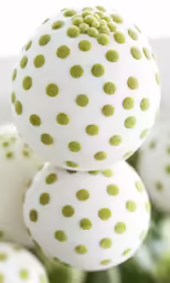white and green polka dot balls in various sizes