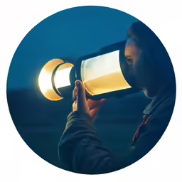 a woman taking a photo on her phone with a flashlight