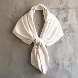 the white scarf that is tied up to hang on a wall