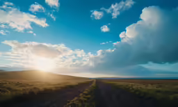 the sun shining through clouds over an empty field