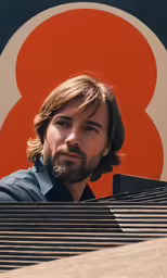 a man with a beard stands behind a metal structure