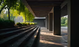 a very dimly lit train station, with trees on both sides