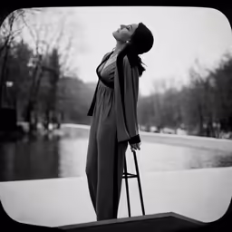 a woman standing on top of a step case in front of water