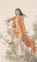 the girl is jumping high in the air