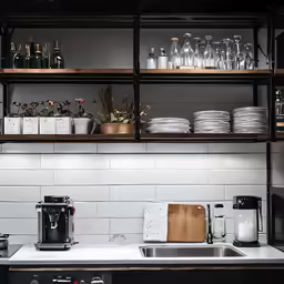 a shelf that has many dishes and cups on it