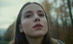 a woman looks up while she holds her nose up in the air
