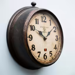 an old clock is sitting on a wall