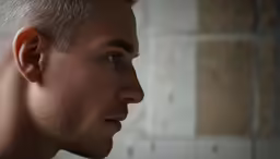 a man with his face shaved looking to the left