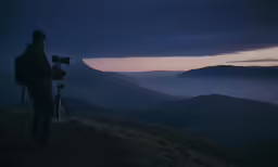 a man taking pictures of the sky with a camera