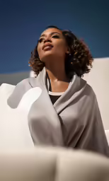 woman wearing a gray scarf over her head