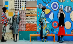 a group of woman standing outside of a building