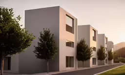 a group of tall white buildings next to a road