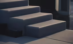 some grey steps to another one on the ground