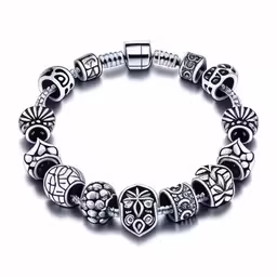 an attractive bracelet with skulls and beads on a white background,an image of a sterling bracelet with skulls