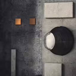 a round mirror on the wall with a concrete floor