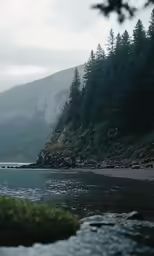 a mountain side and some water next to it