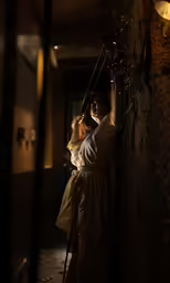 woman in bathrobe with lights and a lantern