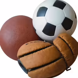 various types of soccer gloves and balls all stacked together