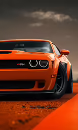 an orange car is sitting in the middle of an orange road