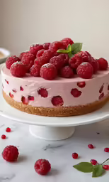 a strawberry cheese cake topped with fresh raspberries
