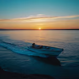 the small motorboat is driving towards the sun