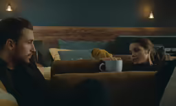 a man and woman are sitting on a couch together
